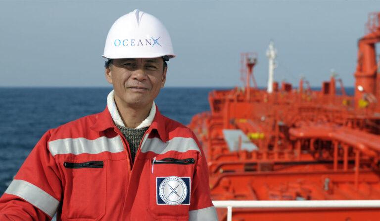 Crew member standing on the deck of an oceanic tanker