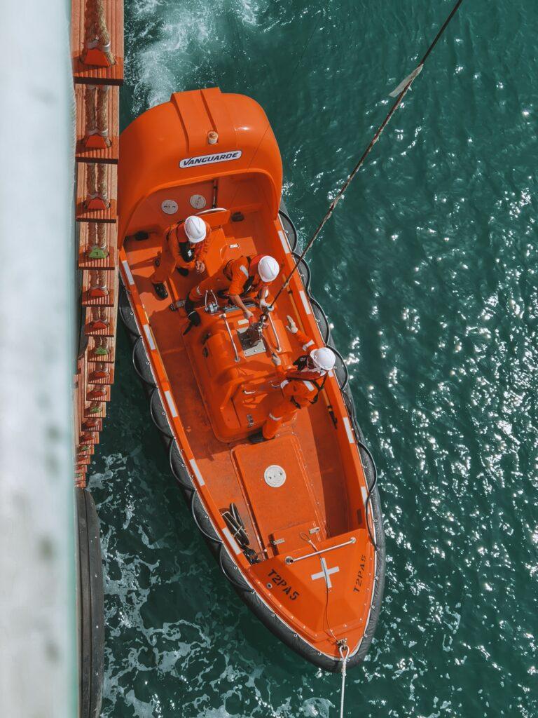 A rescue boat lowered to the sea from ship's deck